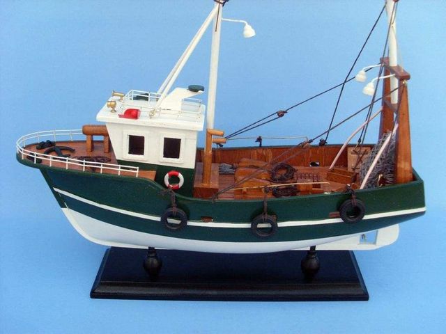 This wooden fishing boat model is attached to a sturdy wooden base